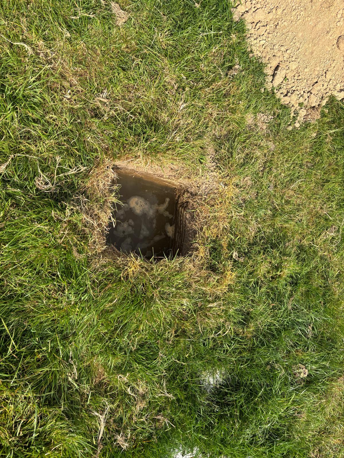 Completed test pit with measurement markers